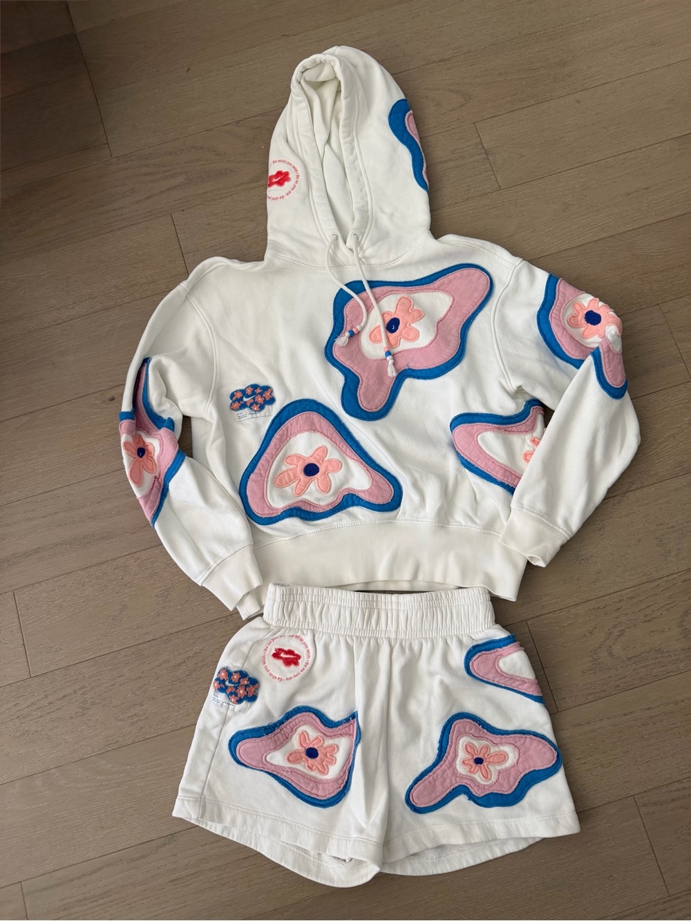 Nike White Athletic Shorts with Pink and Blue Floral Appliqués
